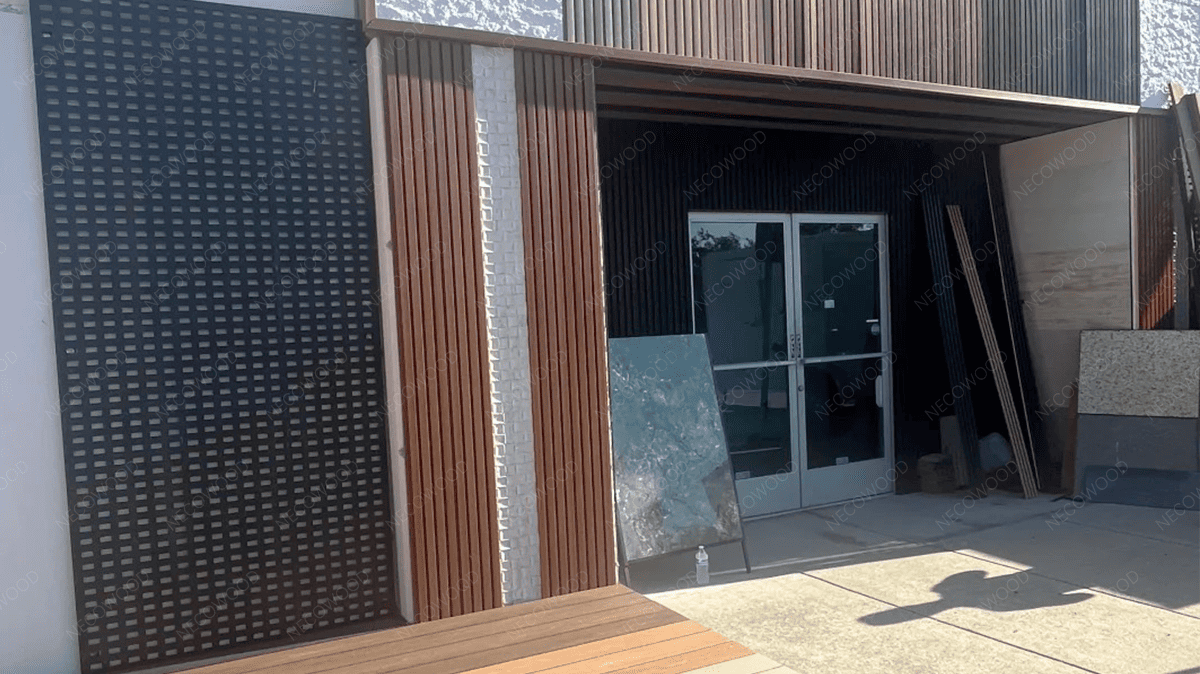 Necowood 360° Shield co-extruded WPC wall panels installed on modern building facade